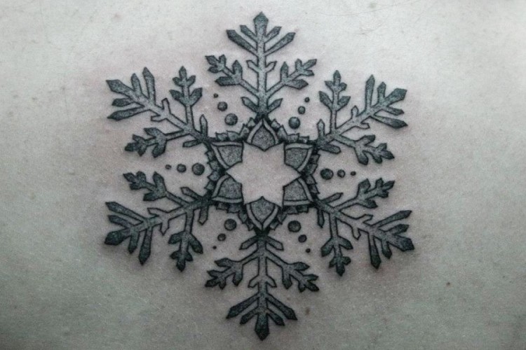 Colorful lower back snowflake tattoos