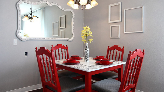 The dining table and chairs are simple wooden affairs and a candelabra with white tapers is