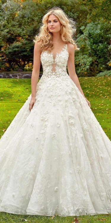 A Cute Curly Woman In A White Wedding Dress With A Wedding Bouquet And Wreath In Her Hair Standing Back To The Camera In Nature