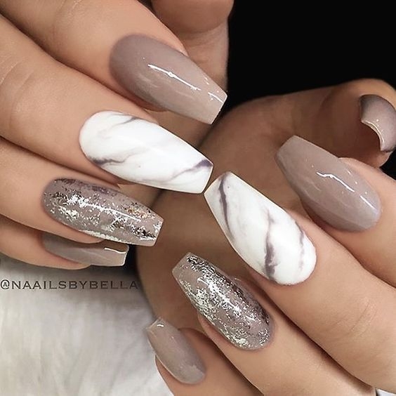 Unusual marble textured nail art design in earthy tones on white